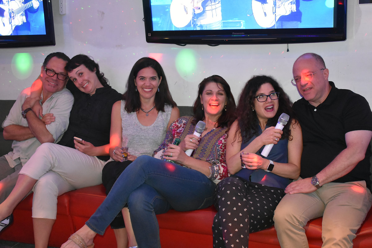 Friends posing in a karaoke room