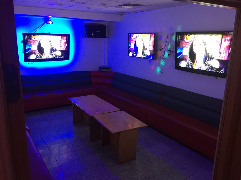 Large karaoke room with multiple screens